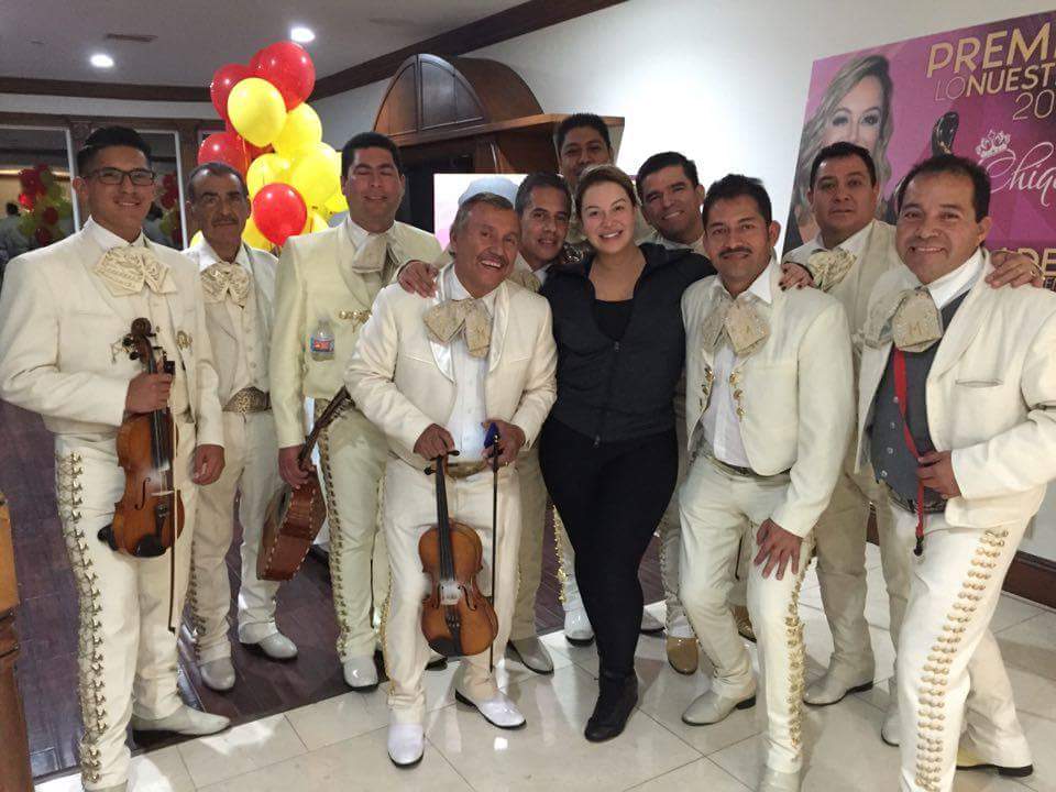 The band celebrating with guests at an awards event
