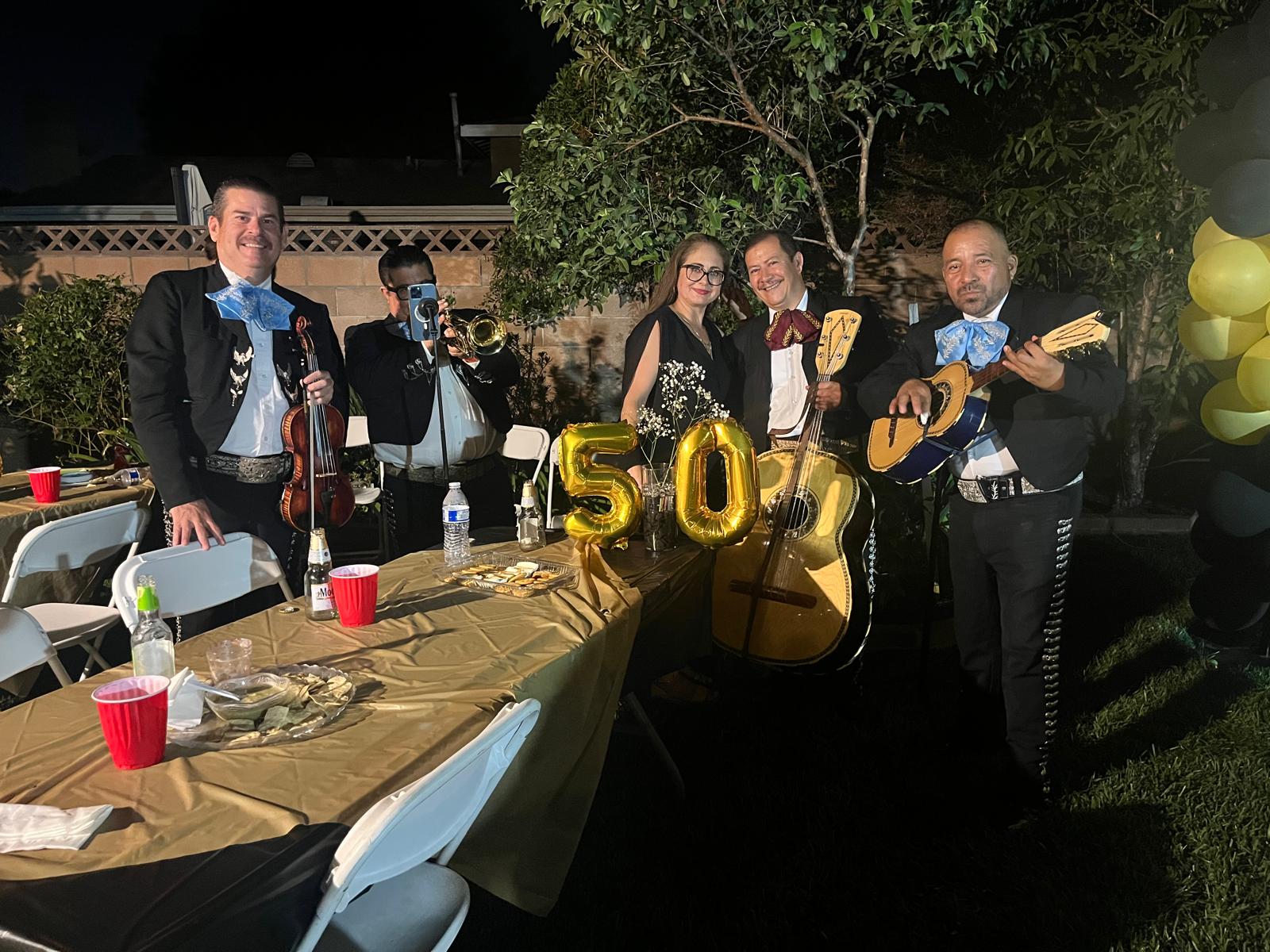 The mariachi band poses at a 50th birthday celebration