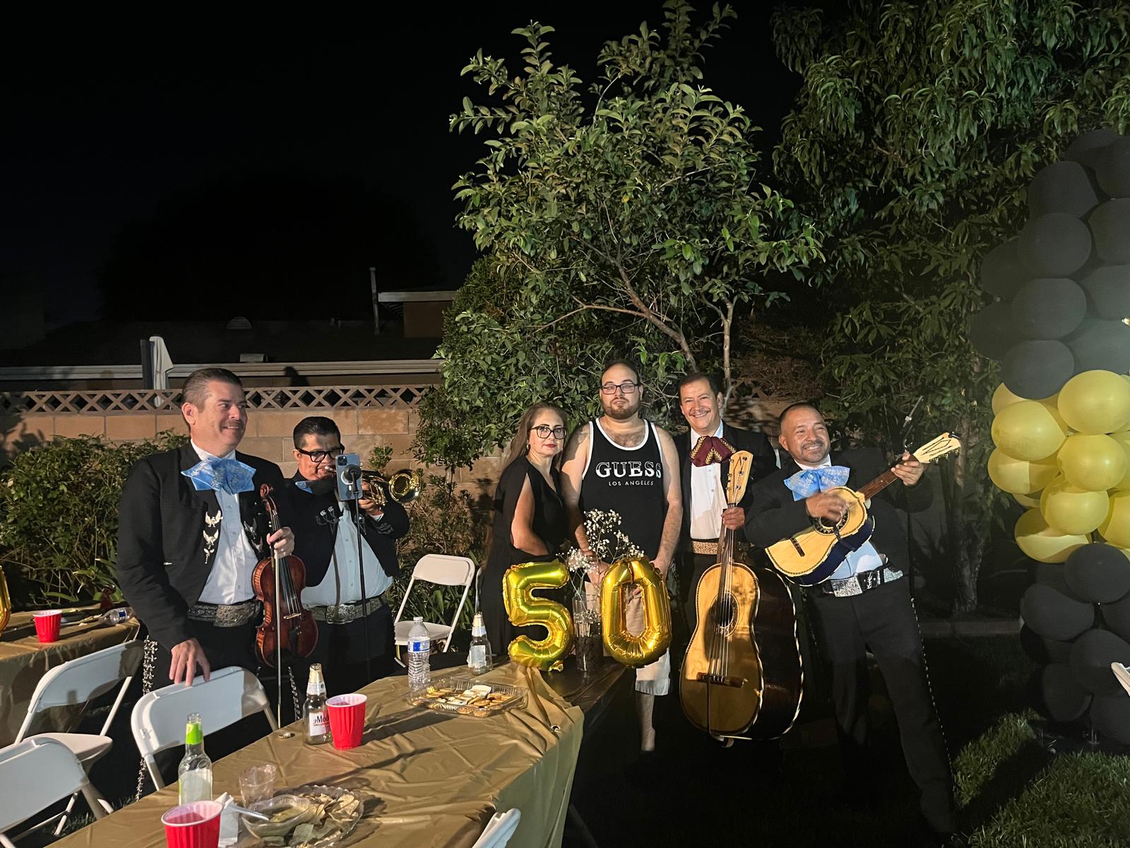 Musicians and guests at a 50th birthday party