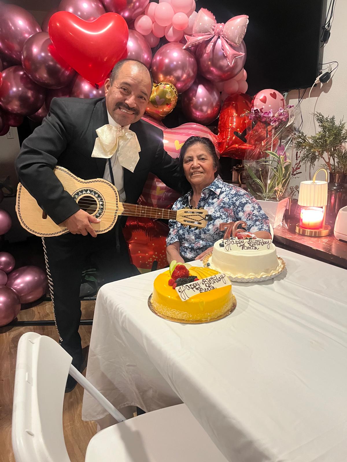 Musician celebrates with a woman and her birthday cakes