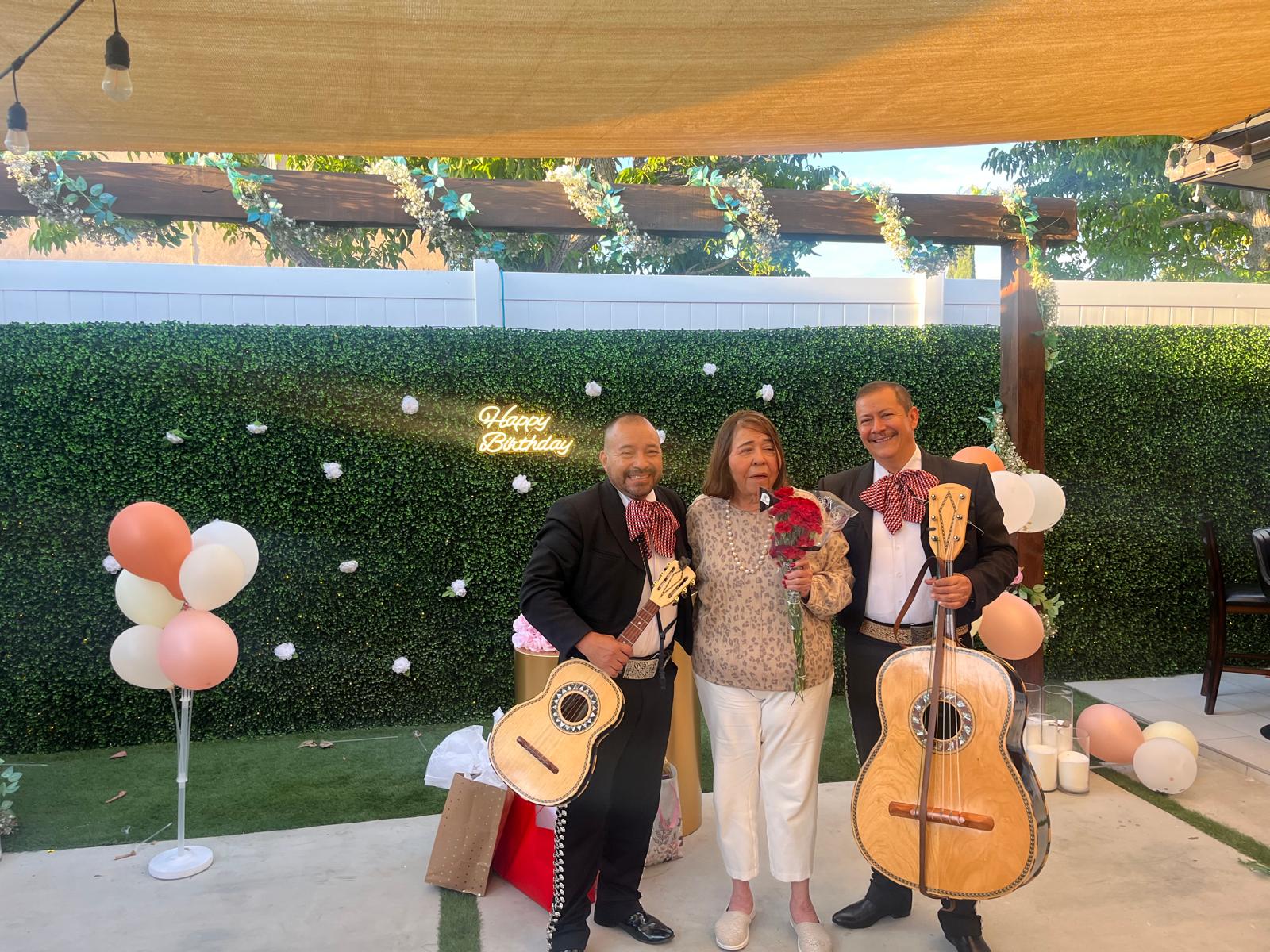 Musicians with a guest at her garden birthday celebration