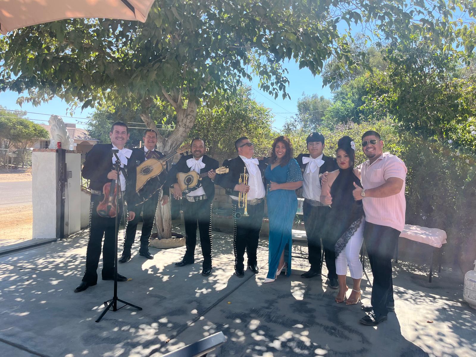The mariachi band and guests at an outdoor gathering