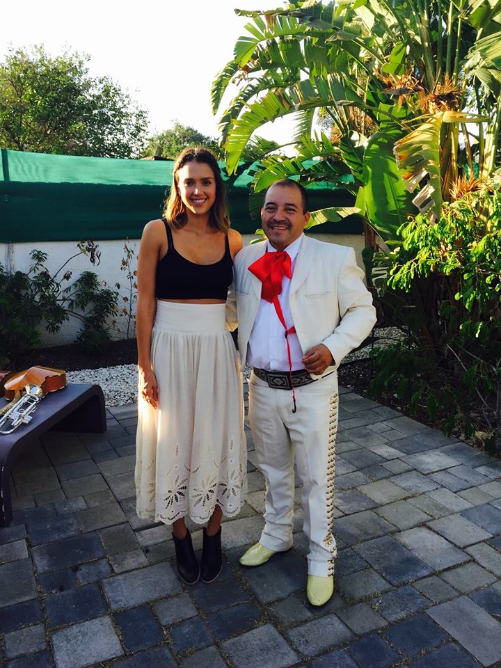 Mariachi musician with a guest in a garden