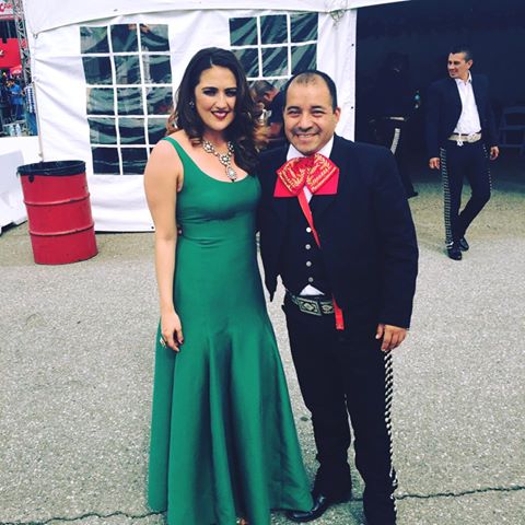 Mariachi musician with a guest in a green dress