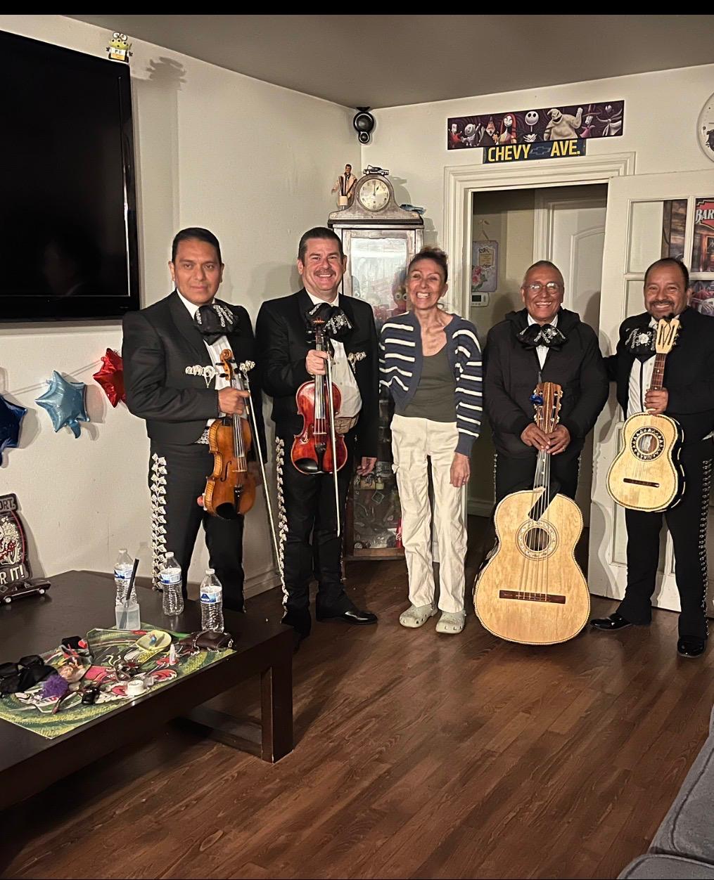 Mariachi musicians with a guest at her home