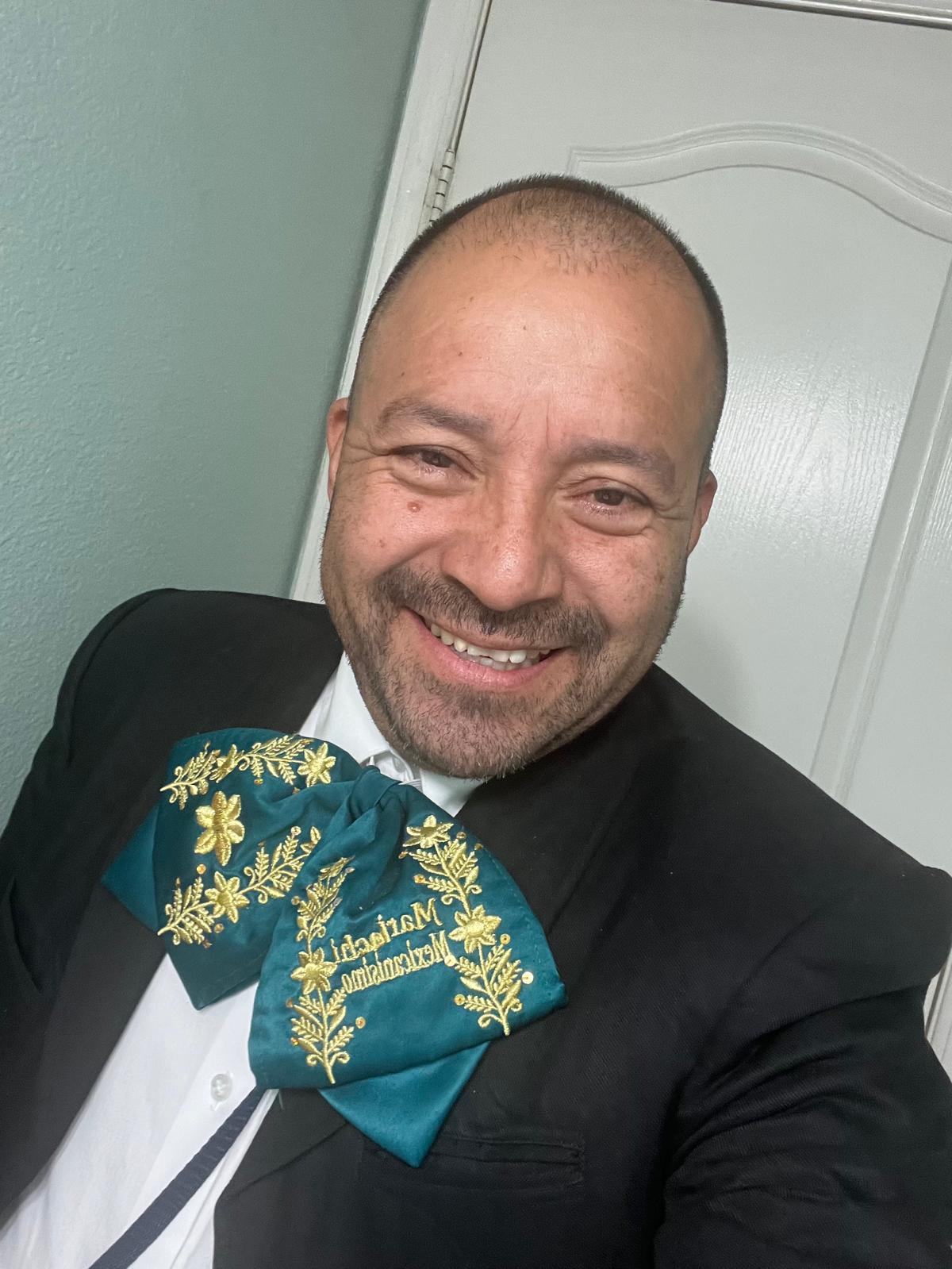 Portrait of a musician wearing an embroidered green bow tie