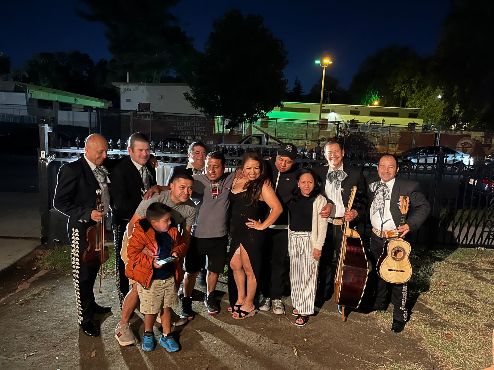 Family members and musicians at an evening celebration