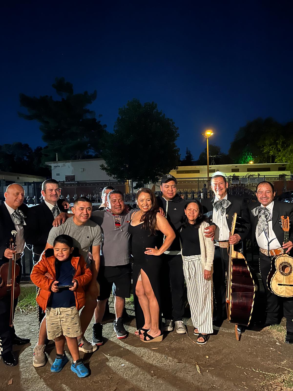 Musicians and family members pose at an evening party