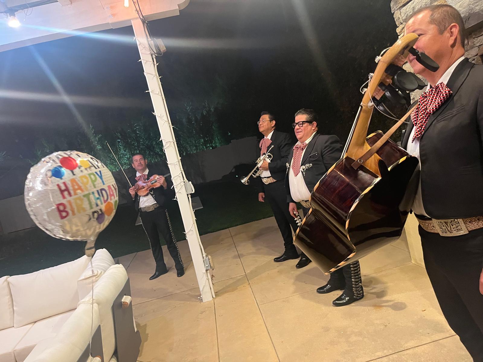 Mariachi musicians perform at an evening celebration