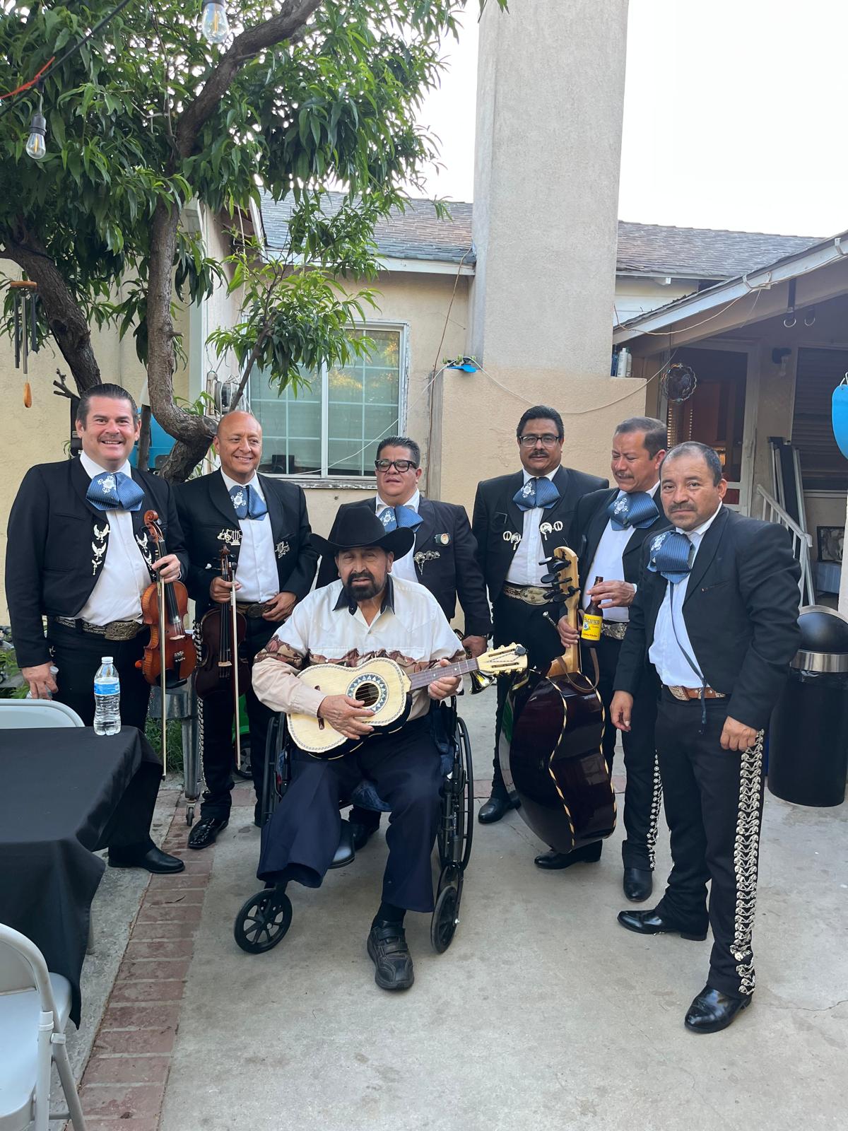 The mariachi band with a guest at a backyard gathering