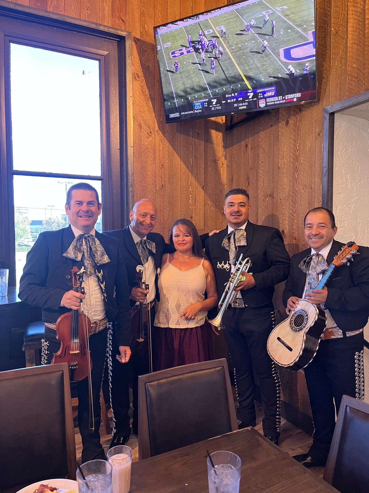 Musicians with a guest at a restaurant