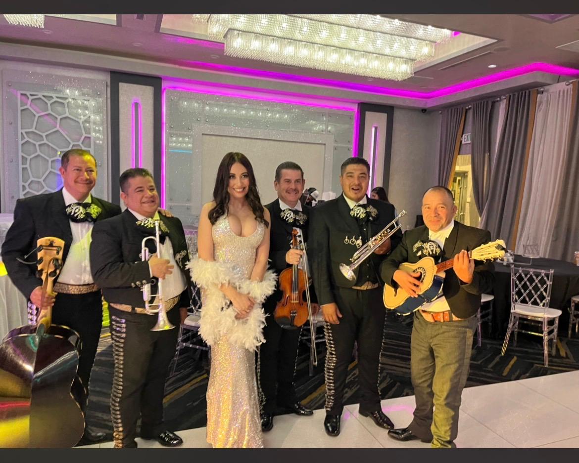 The mariachi band with a guest at a wedding