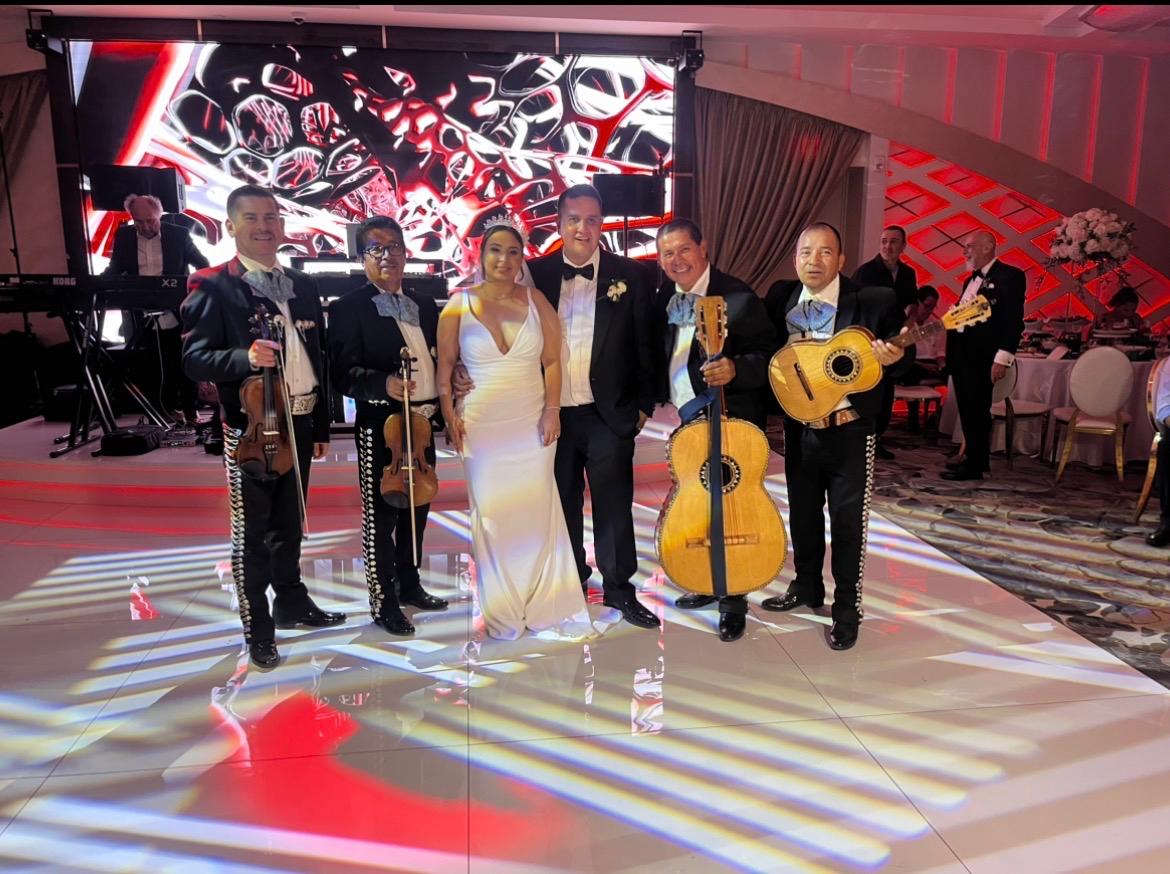 The mariachi band celebrates with newlyweds