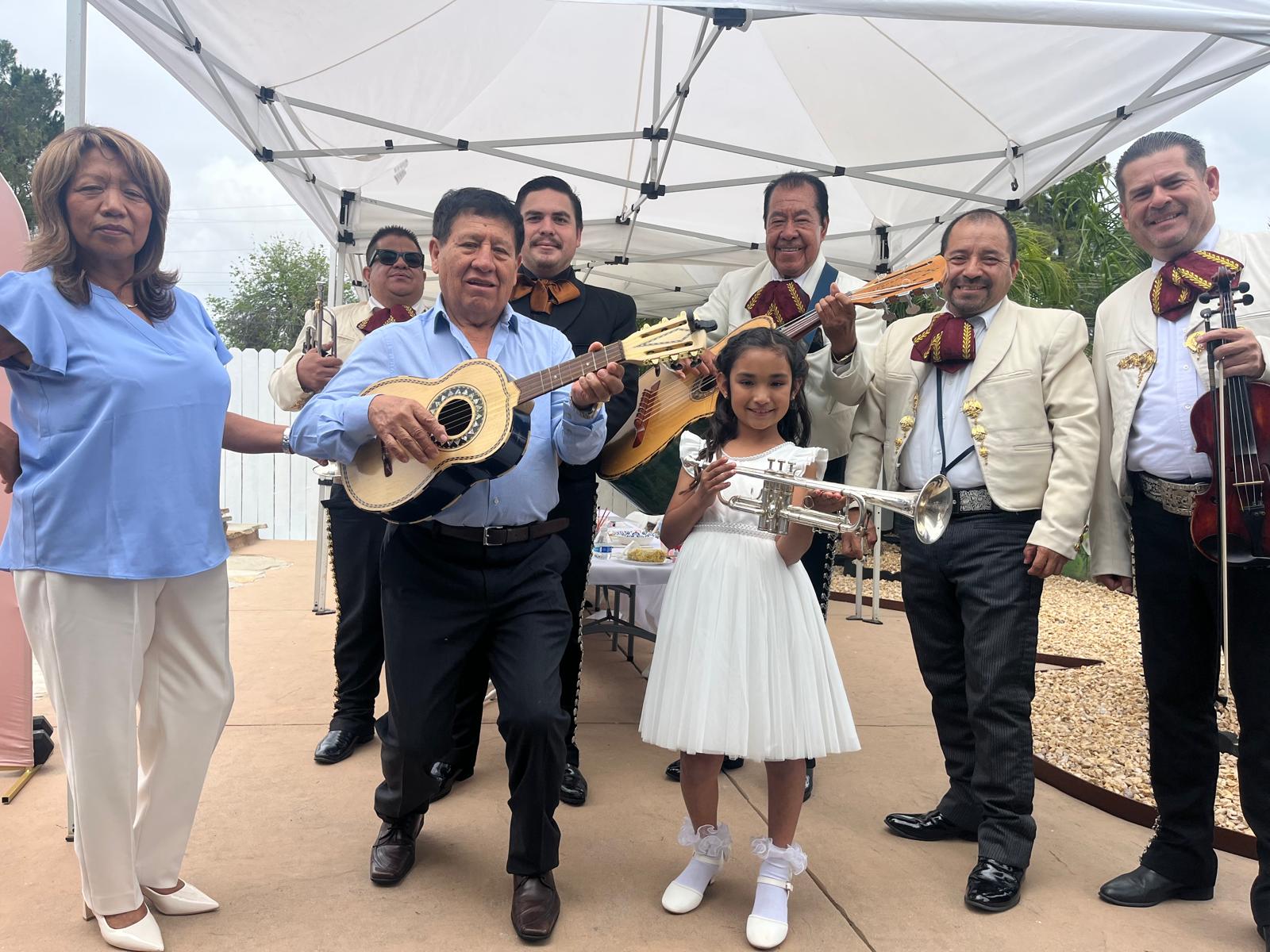 The mariachi band with a family during a celebration