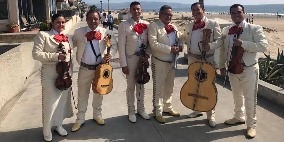 Mariachi musicians with their instruments by the sea